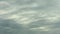 Time lapse dark cumulus clouds receding into the distance
