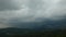 Time lapse dark heavy clouds run over sky, Barcelona mountains panorama