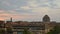 Time lapse of dark storm clouds, day to night, in unidentifiable urban background.