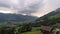 Time lapse of a developing thunderstorm over the Alps with falling rain in the valley