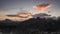 Time lapse of dramatic sunset with moving clouds in sky over mountain silhouettes in the Dolomite Alps at Three Peaks, South Tyrol