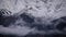 Time lapse of epic snowy misty mountains