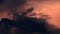 Time lapse of epic sunrise rising above clouds with fiery glow, burning red sun