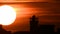 Time lapse - Extreme close up of the sun setting with dramatic clouds at sunset