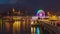 Time lapse, Ferris wheel at night. Observation wheel in medieval european town next to the lake. Rapperswil-Jona, Canton St.