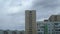 Time-lapse of floating clouds over a provincial city. Panel old multistoried houses with balconies.