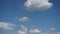 Time-lapse of fluffy white clouds moving across Arizona desert sky.