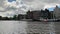 Time lapse footage of people riding boats on Amstel river in Amsterdam. Historical and traditional buildings