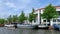 Time lapse footage of people riding many boats on Amstel River in Amsterdam.