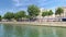 Time lapse footage of Seine river, bridges and historical buildings in Paris. It is a sunny summer day.