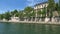 Time lapse footage of Seine river, bridges and historical buildings in Paris. It is a sunny summer day.