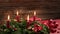 Time lapse of four burning red candles on a advent wreath with festive decoration