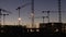 Time lapse FullHD video of construction cranes and workers silhouettes