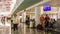 Time lapse hyper lapse of the airport waiting room with people walking and close up on the arrivals and departures billboard