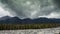 Time lapse of majestic mountains, moving clouds, forest and stones. East Sayan