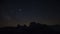 Time lapse of milky way and night sky with stars over Dolomite Alps at Three Peaks in summer, South Tyrol Italy