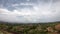 Time lapse motion the clouds move fast on the sky in the daytime bright and the cars on the road that drive up the mountain at