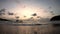 Time lapse motion sea waves that hit the beach and boat Background clouds are moving fast and Golden light of sunrise in the