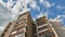 Time lapse the movement of clouds over a modern multi-storey building in the center of Moscow. A beautiful tall building