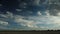 Time Lapse - Moving clouds over a field in autumn with Frankfurt am Main in the distance