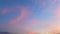 Time lapse of moving colorful clouds in the evening at sunset.
