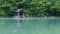 Time lapse of mysterious fog around a small boathouse on a lake in the forest.