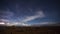 Time lapse of night skies with cloud movement and storm activity on the horizon