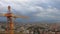 Time-lapse: Orange crane on a background moving clouds