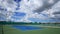 Time-lapse of outdoor empty tennis court with blue sky and cloud