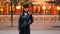 Time-lapse portrait of tired Asian girl standing in pedestrian street with hand in pocket and looking at camera then