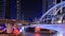 Time-lapse of public sky walk and traffic at Chong Nonsi sky train station at night, Bangkok, Thailand