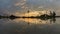 Time lapse reflection sunset with golden cloud, coconut trees.