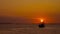 Time lapse, The scenery of the setting sun, with a fishing boat floating in the sea, lonely lonely atmosphere