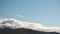 Time lapse serene blue sky with fluffy clouds rolling over the mountains and thick vegetation shot in Tasmania, Australia