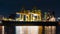 Time-lapse of shipping port with cargo container ship, crane, in Asia city at night. Logistic industry, industrial business