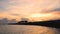 Time lapse of silhouette happy people and family walking on the bridge over the sea along edge of sunset beach.