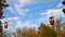 Time-lapse of a small cable car. Multicolored cabs float against the blue sky.