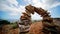 Time lapse of a stone arch against the background of the sky with clouds. Balanced stone pyramid. Stacked stones pyramid on the