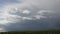 Time lapse of stunning dramatic clouds over a field