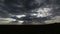 TIME LAPSE of the sun rays break through clouds on vivid blue sky.