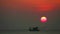 Time lapse sunset red sky on sea and silhouette fishing boat