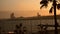 Time lapse at sunset with view of barceloneta beach in barcelona, spain, with palm trees and sun setting