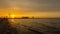 Time lapse sunset with waves on the lake with lighthouse