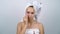 Time lapse teenager with acne wrapped in bath towels applying face cream