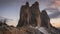 Time lapse of Three Peaks during colorful sunset with moving clouds, national park in Dolomite Alps, Italy