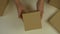 Time lapse top view. Hands of a man unpack gift boxes. The man takes the boxes one from the other. Many boxes of