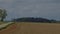 time lapse of tractor harrowing agricultural field in spring