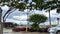 Time-lapse Traffic and a car dealership parking lot cloudy sky