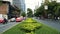 Time lapse transport traffic on the roadway in green downtown at sunny day