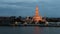 Time lapse of twilight view of Wat Arun across Chao Phraya River during sunset in Bangkok